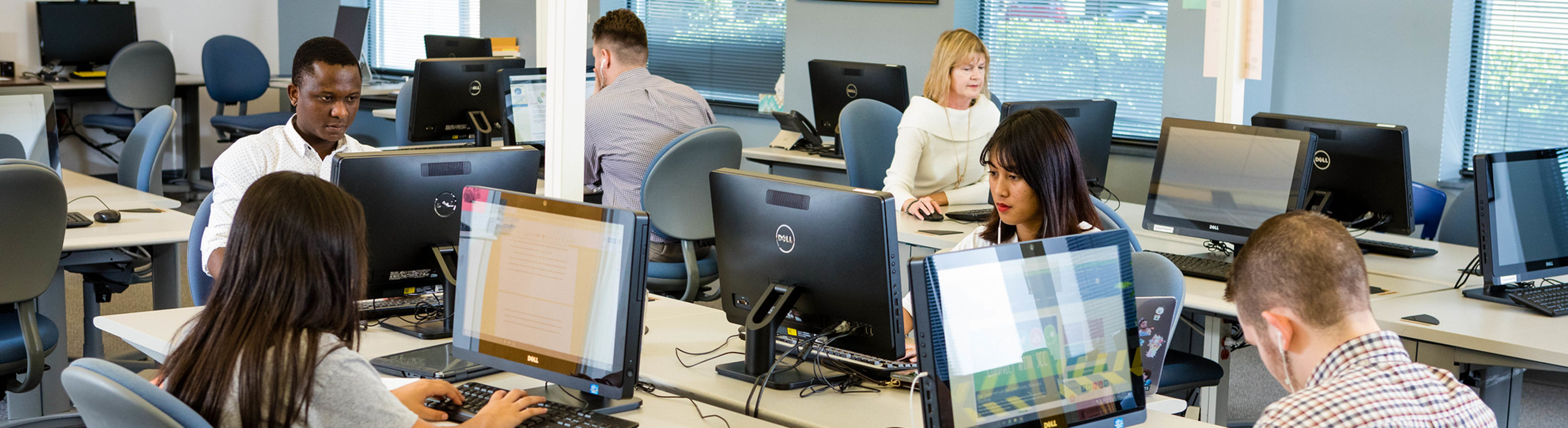 Students sitting at computers concentrating on their studies inside a classroom