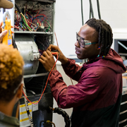 SCC student hands on working on HVAC unit