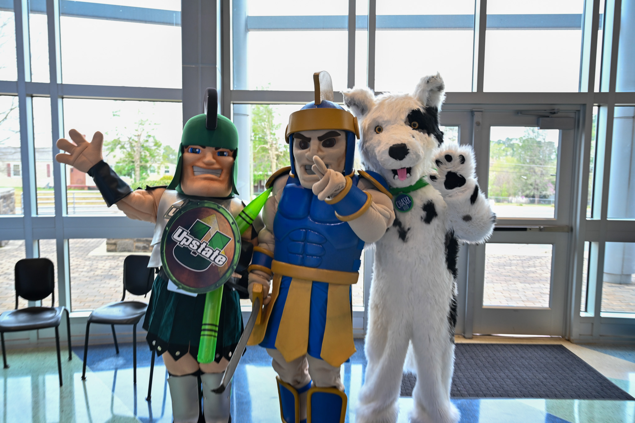 Mascots for SCC, USC U, and SSD3 stand together.
