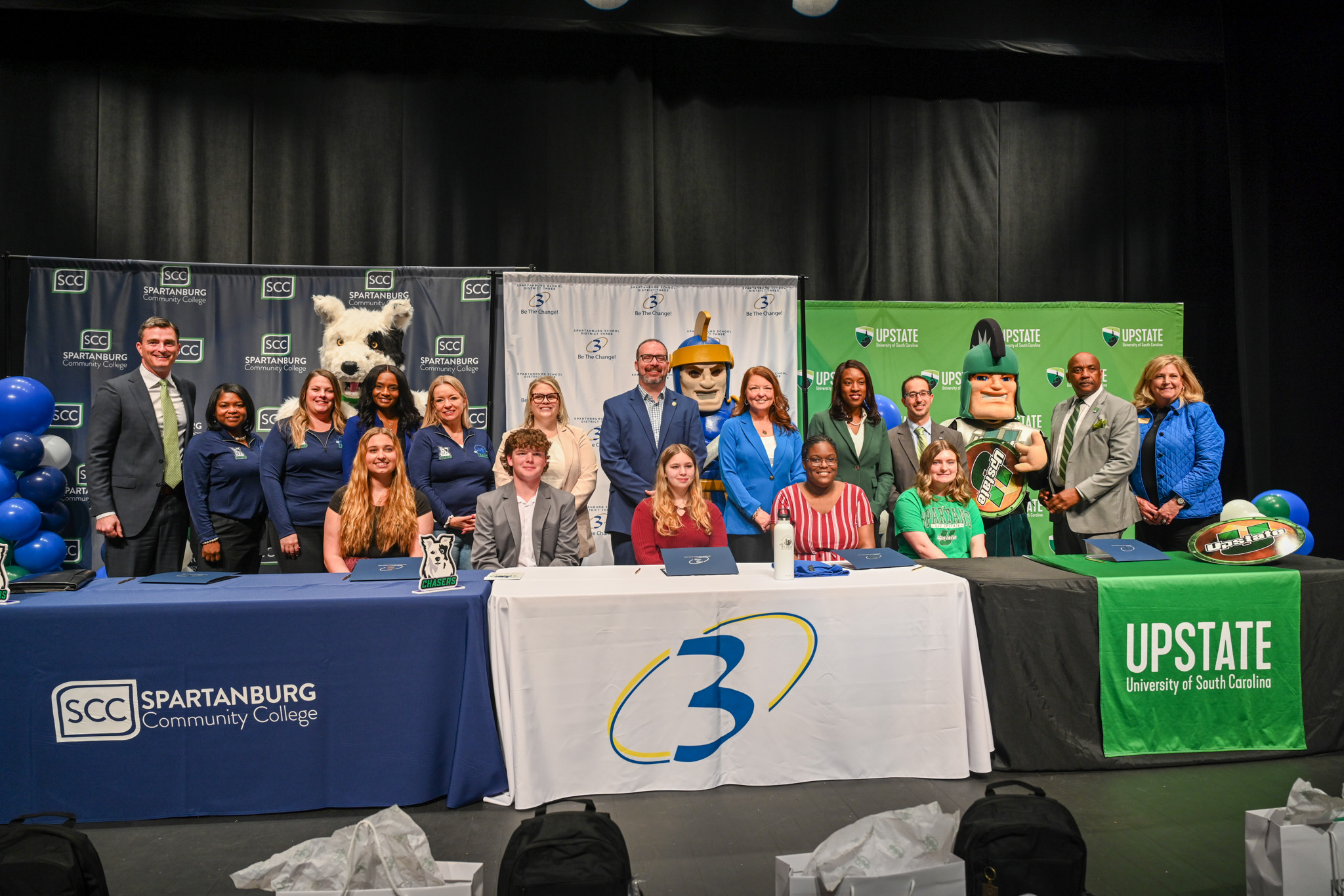 Representatives from SCC, USC Upstate, and Spartanburg School District 3 sit together with newly inducted students.