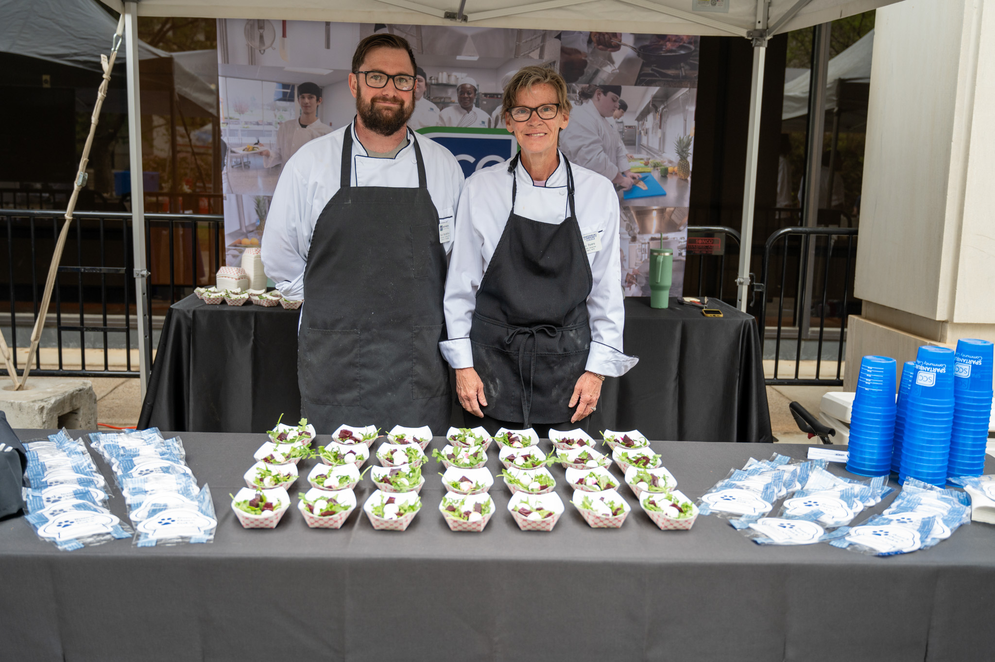 Image of Two Culinary Instructors as they present their dish.
