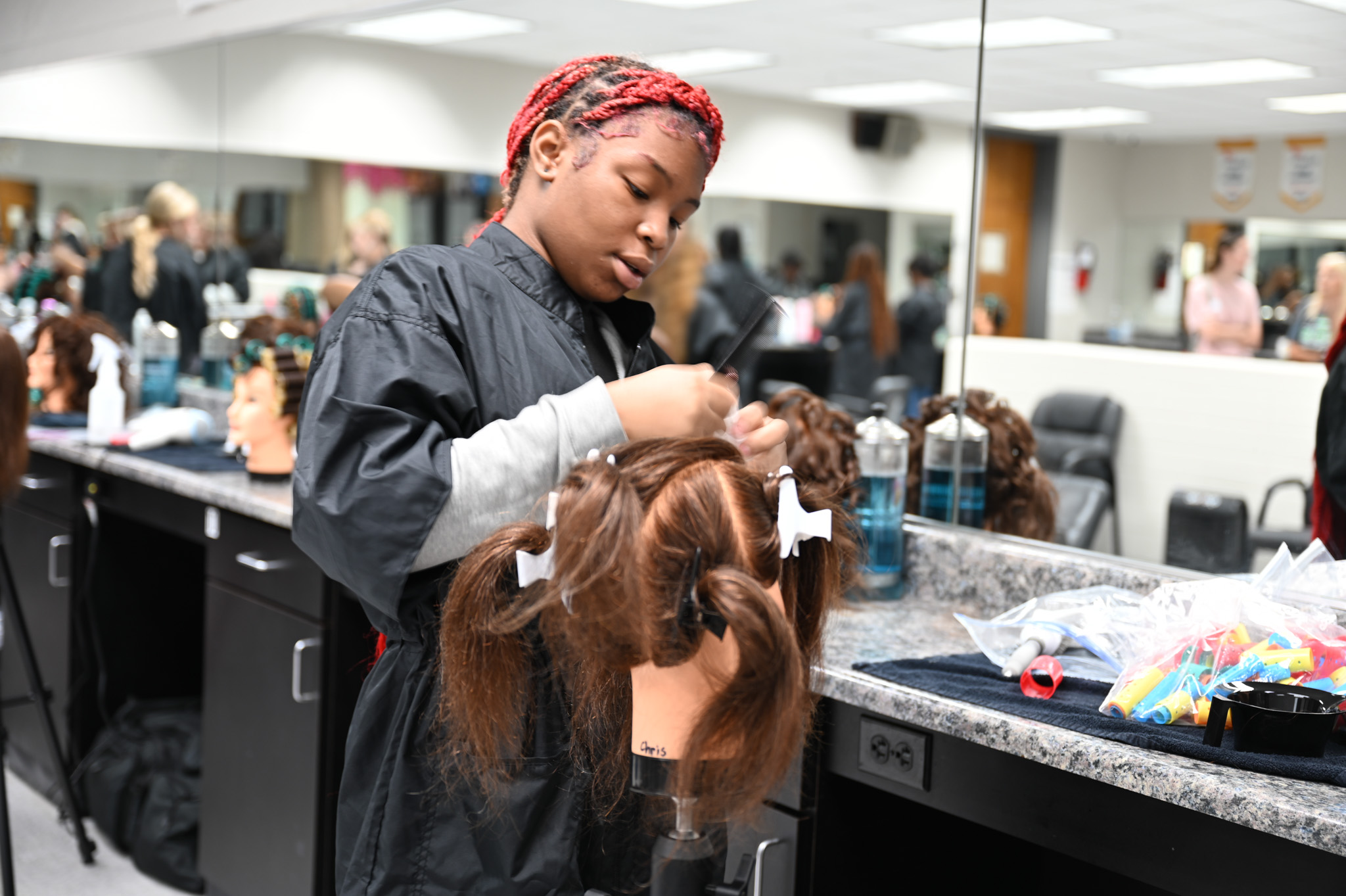 Cosmetology Student practices on mannequin