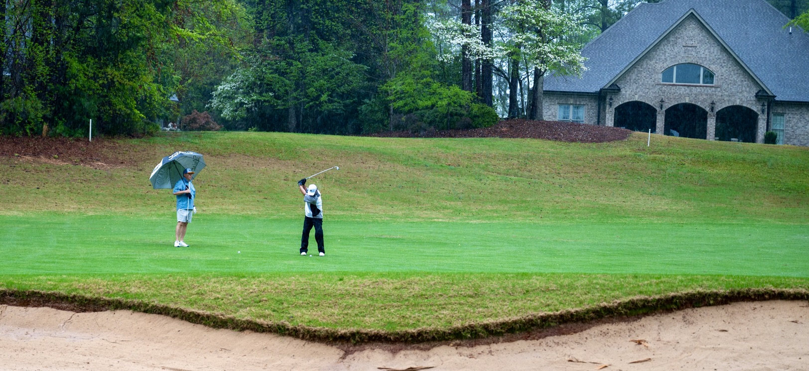 Golfers enjoy golfing in the rain at Chaser's 3rd Golf Tournament