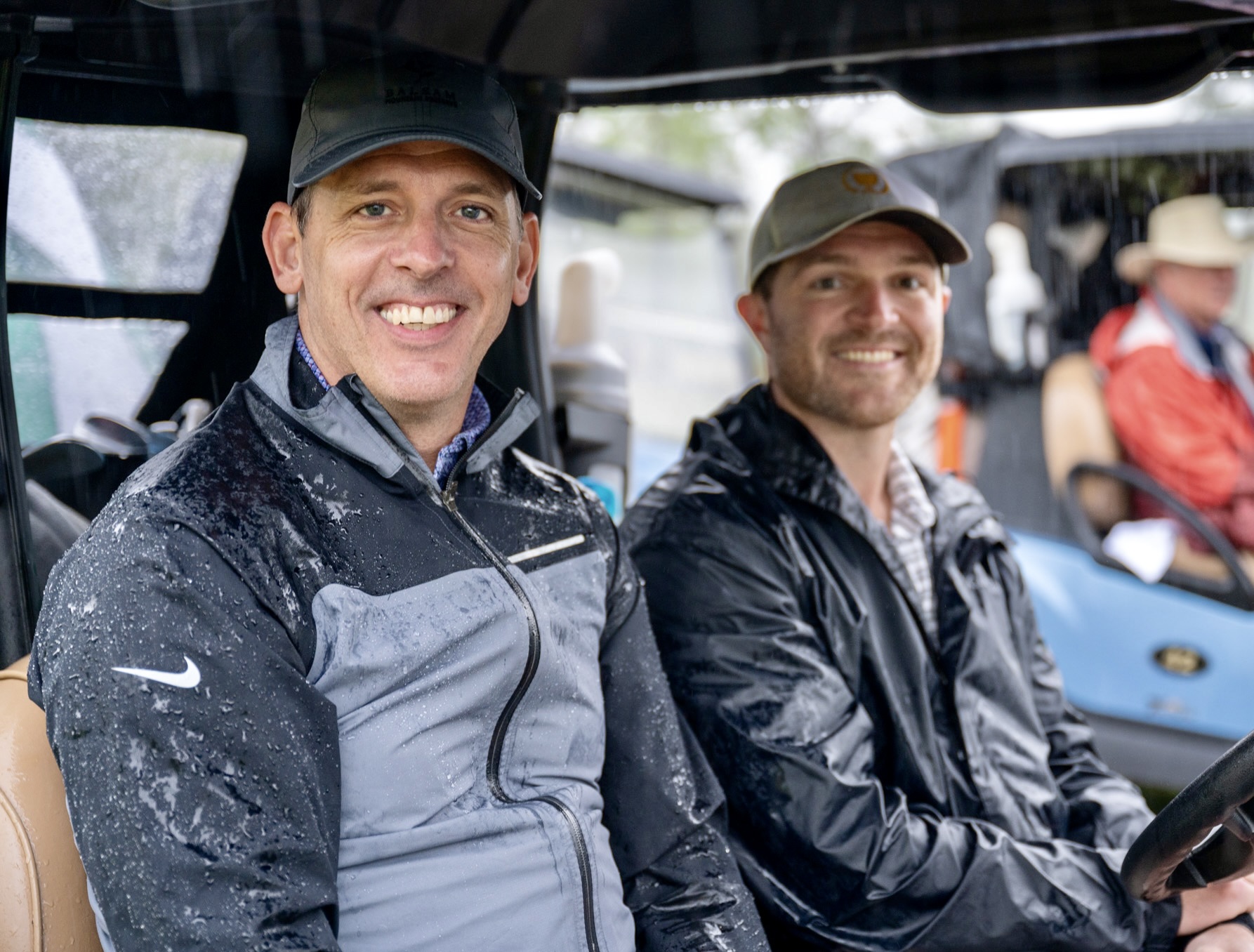 Two golfers enjoy the rain at Chaser's 3rd Annual Cup