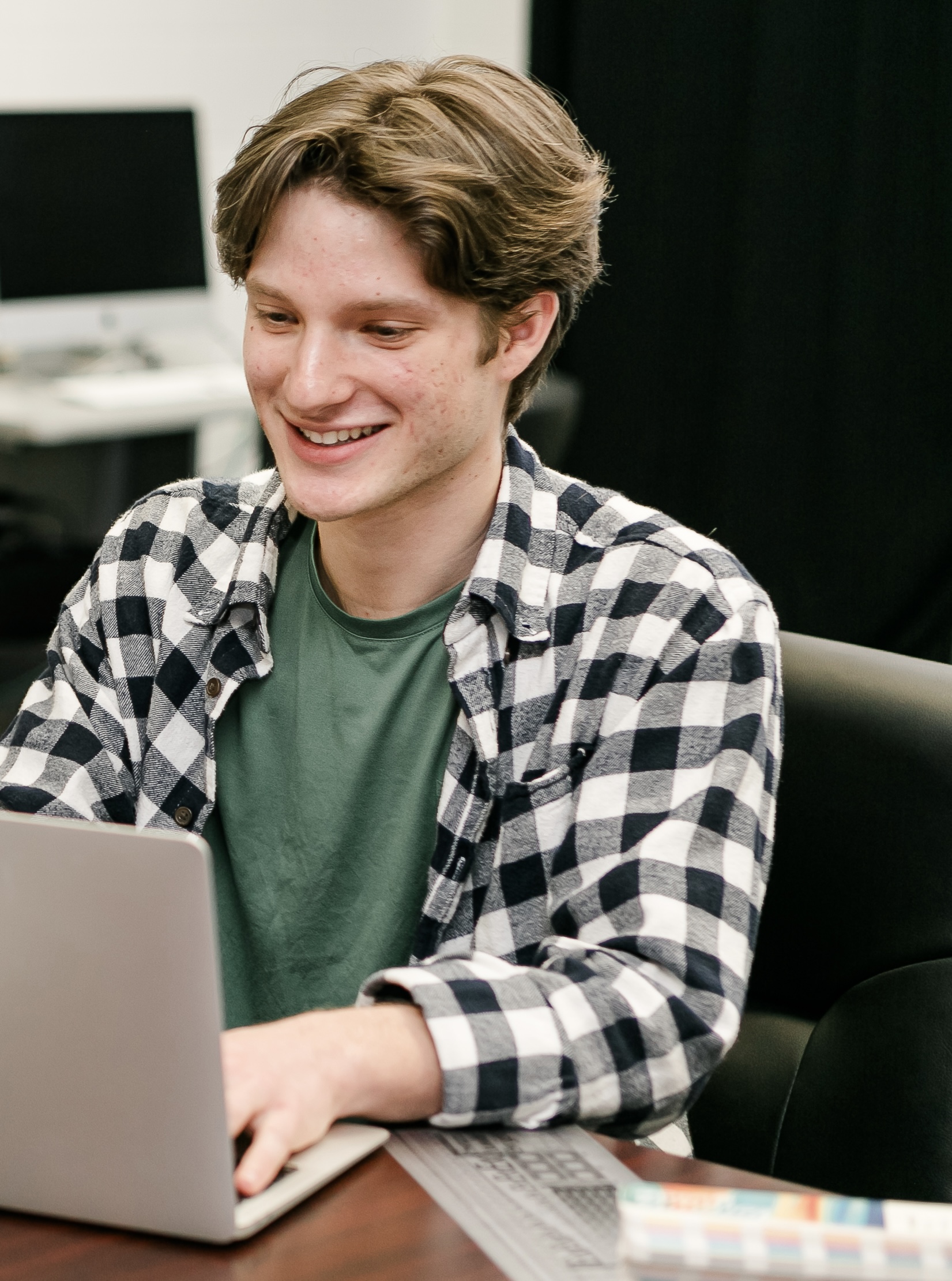 An SCC Student writes on his computer.