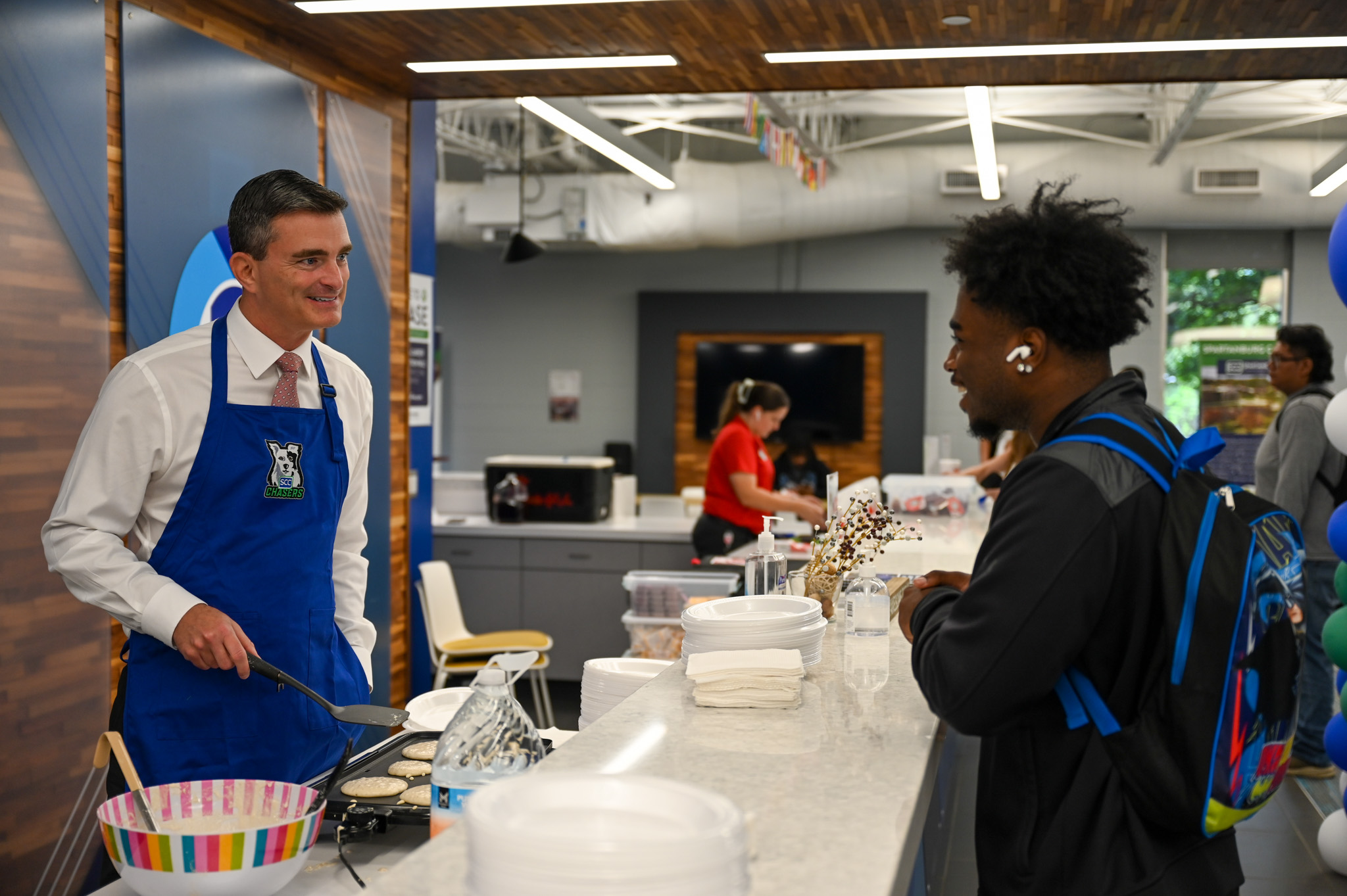 Dr. Mikota serves breakfast at SCC
