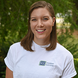 Spartanburg Community College Chasers shirt portrait, SCC branded apparel outdoor headshot, campus greenery background professional image, college student lifestyle photography